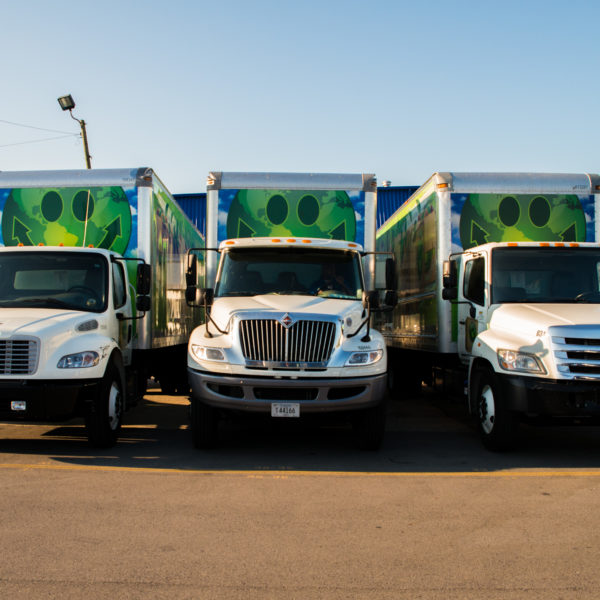 The Green Truck Moving & Storage Company trucks lined up